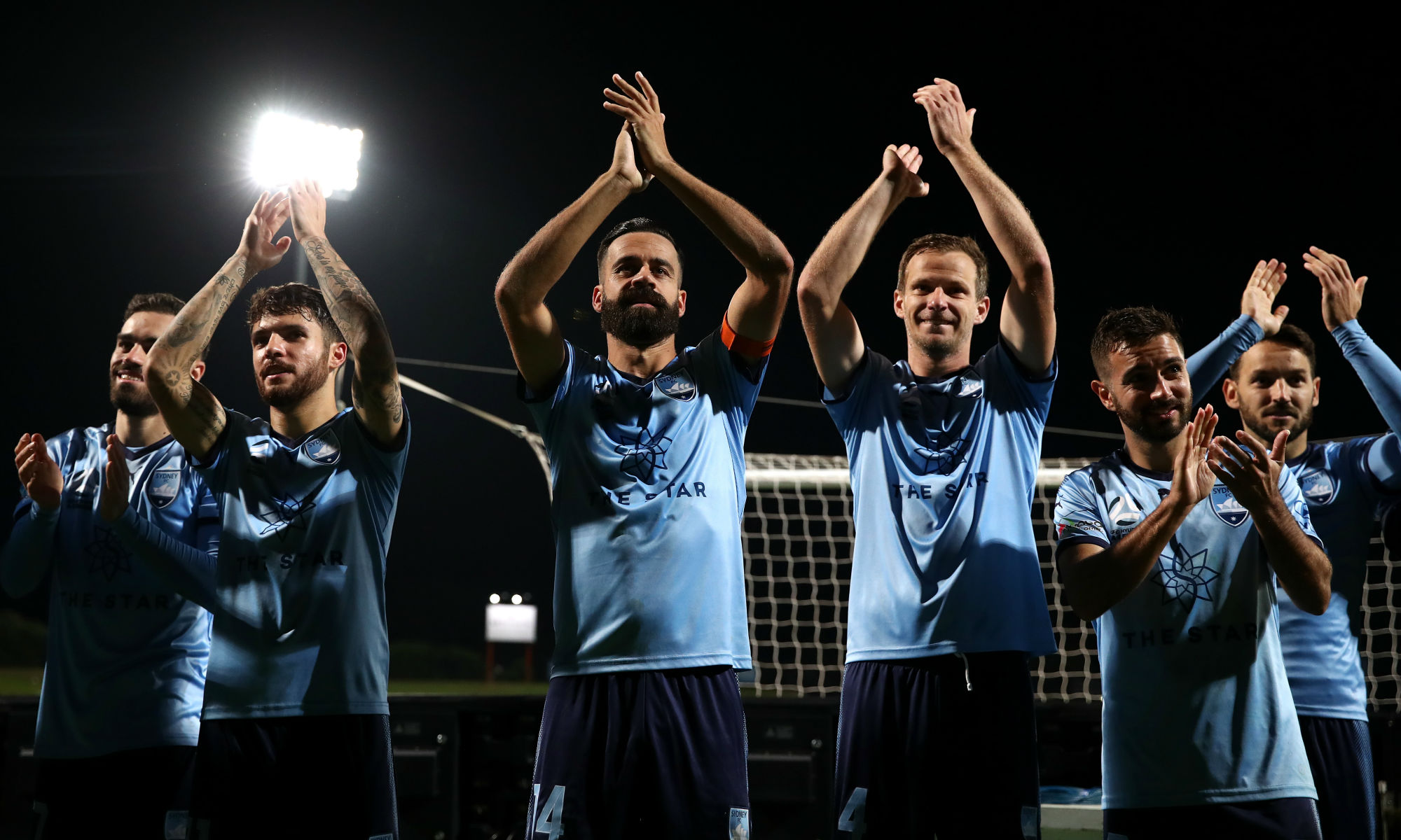 Sydney FC players celebrate their 6-1 Semi-Final win against Melbourne Victory at Netstrata Jubilee Stadium.